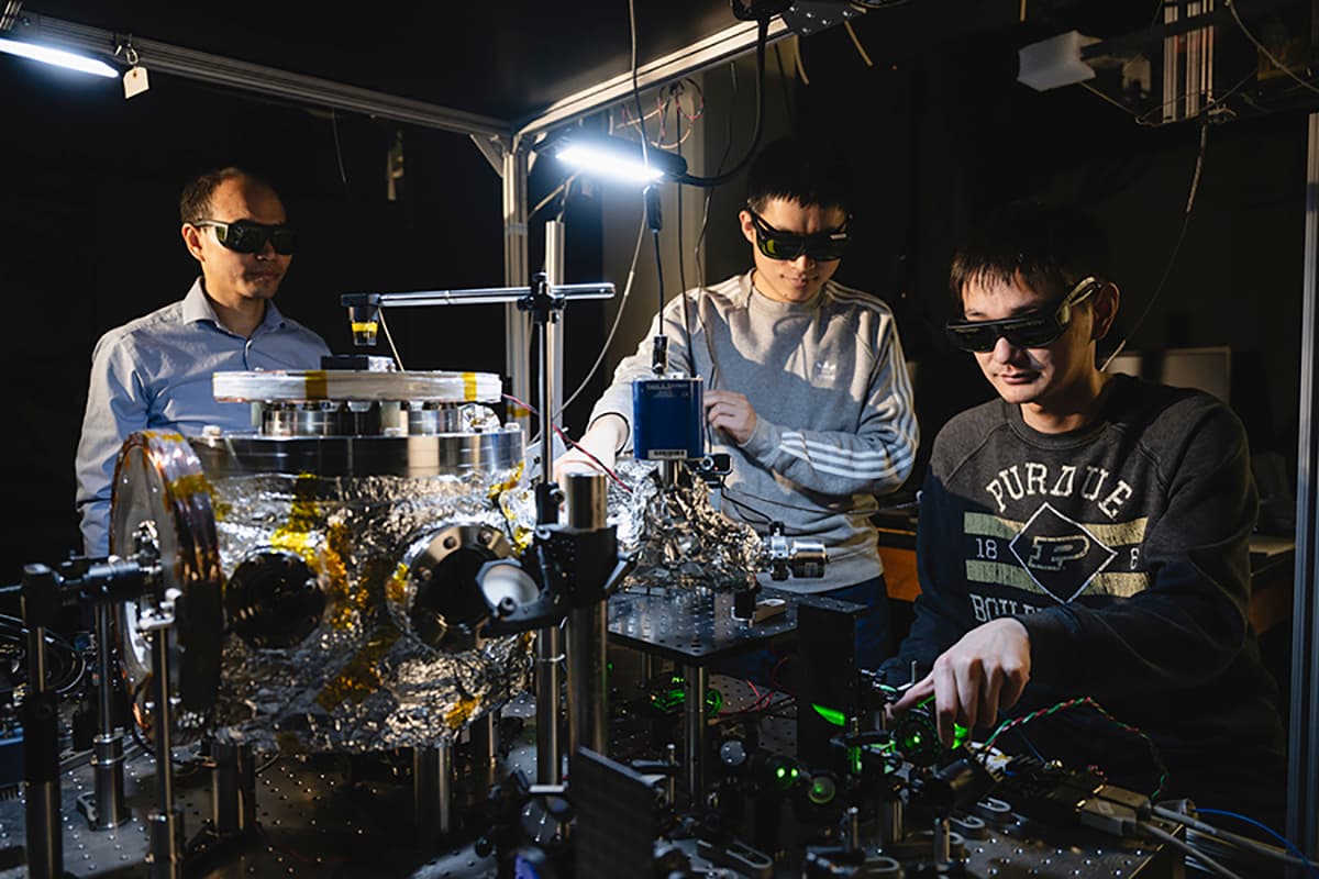 Prof. Tongcang Li (left), Dr. Yuanbin Jin (middle) and Kunhong Shen perform experiments with levitated and rotating fluorescent diamonds at Purdue University