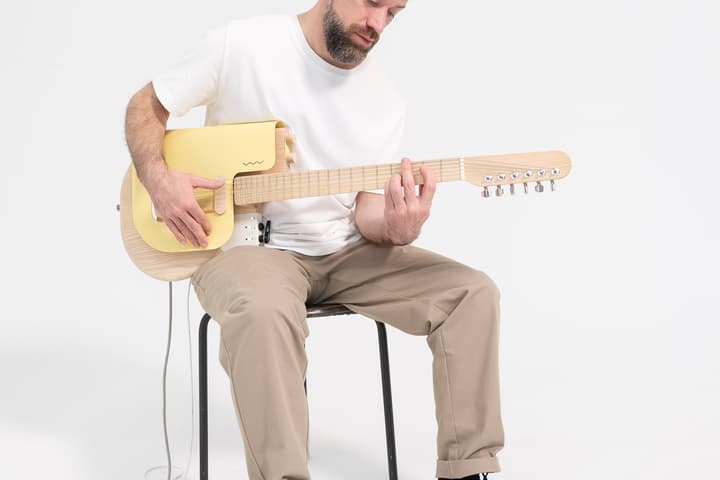 This strange-looking guitar features "freely movable pickups" for tone versatility, a "spring-loaded" metal plate for shimmer, and an active expression module to control external hardware