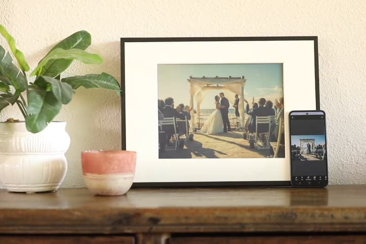 The Reflection Frame's ePaper visuals are updated with a tap of a smartphone running a companion mobile app