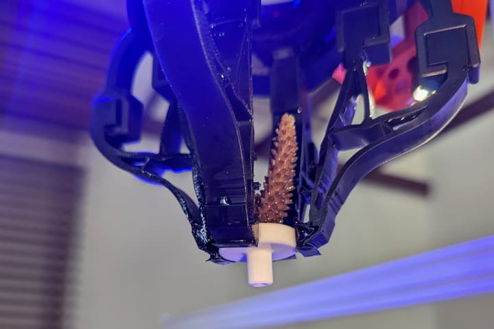 The 3D-printed gripper is made mainly of hard polymer and soft rubber parts