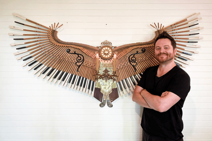 Australian sculptor David Cox with his 50th Phoenix sculpture, built as a tribute to a well-loved piano